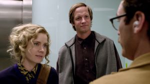 Theodore (Joaquin Phoenix) bumps into good friend Amy (Amy Adams) and her husband Charles (Matt Letscher) in Her