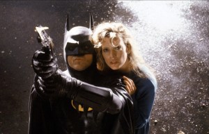 Batman (Michael Keaton) protects reporter Vicky Vale (Kim Basinger) in Batman