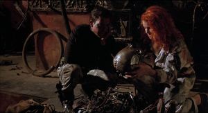 'Hard Mo' Baxter (Dylan McDermott) presents a gift of a robot head to girlfriend Jill (Stacey Travis) in Hardware